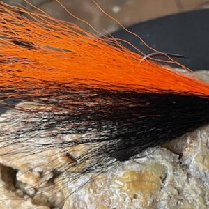 black and orange bucktail fishing lure